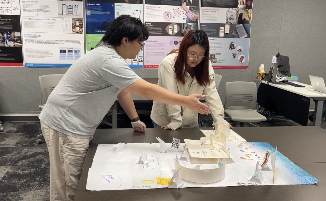 Team walking a participant through the scenario at the cardboard model