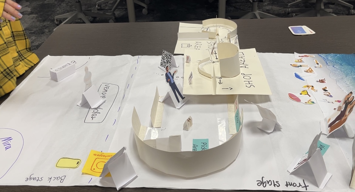 Close-up of the cardboard pop-up counter with mirror and brand signage