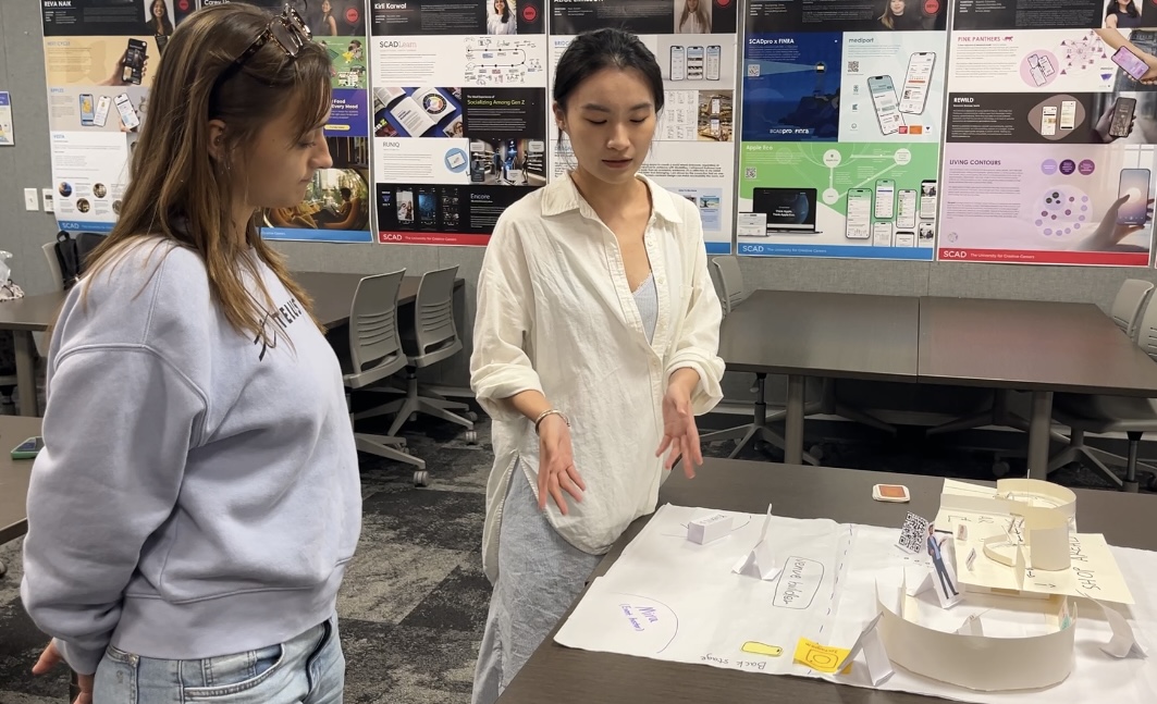 Team observing and taking notes during a prototype walkthrough session