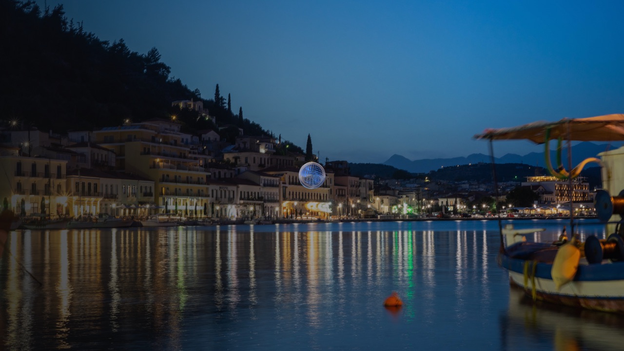 Early blue glass orb over a nighttime harbor